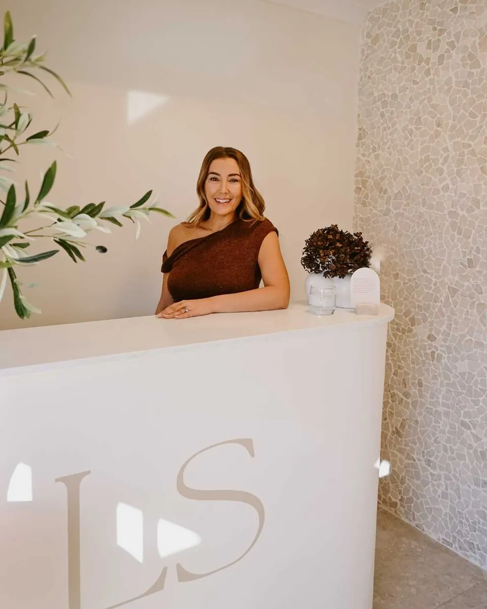 Aydan at the reception desk of Love Skin With Aydan